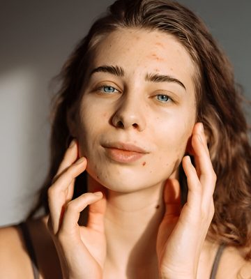 a woman with her hands on her face